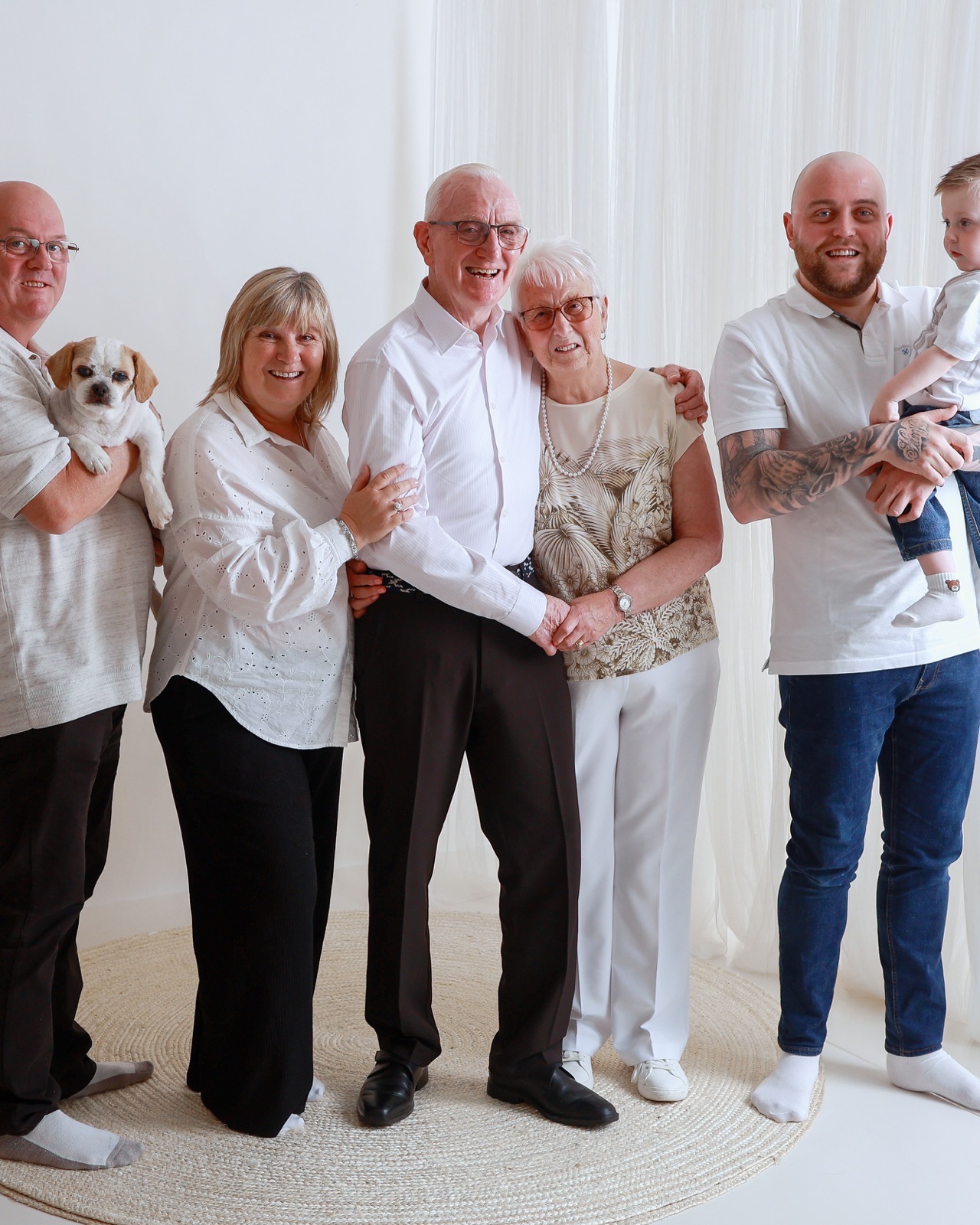 Extended family of five with a small dog, grandparents in the centre