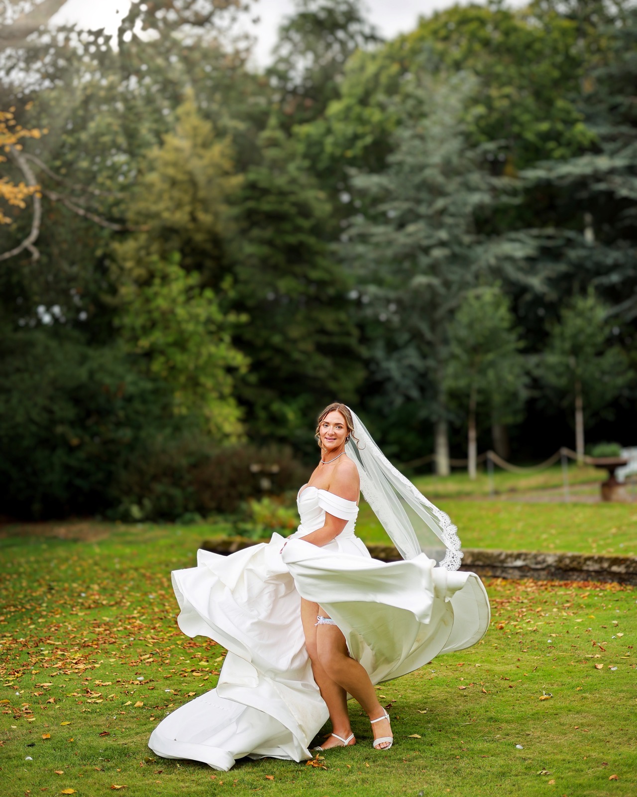 Bride twirling her wedding dress, laughing, skirt fanned out dramatically